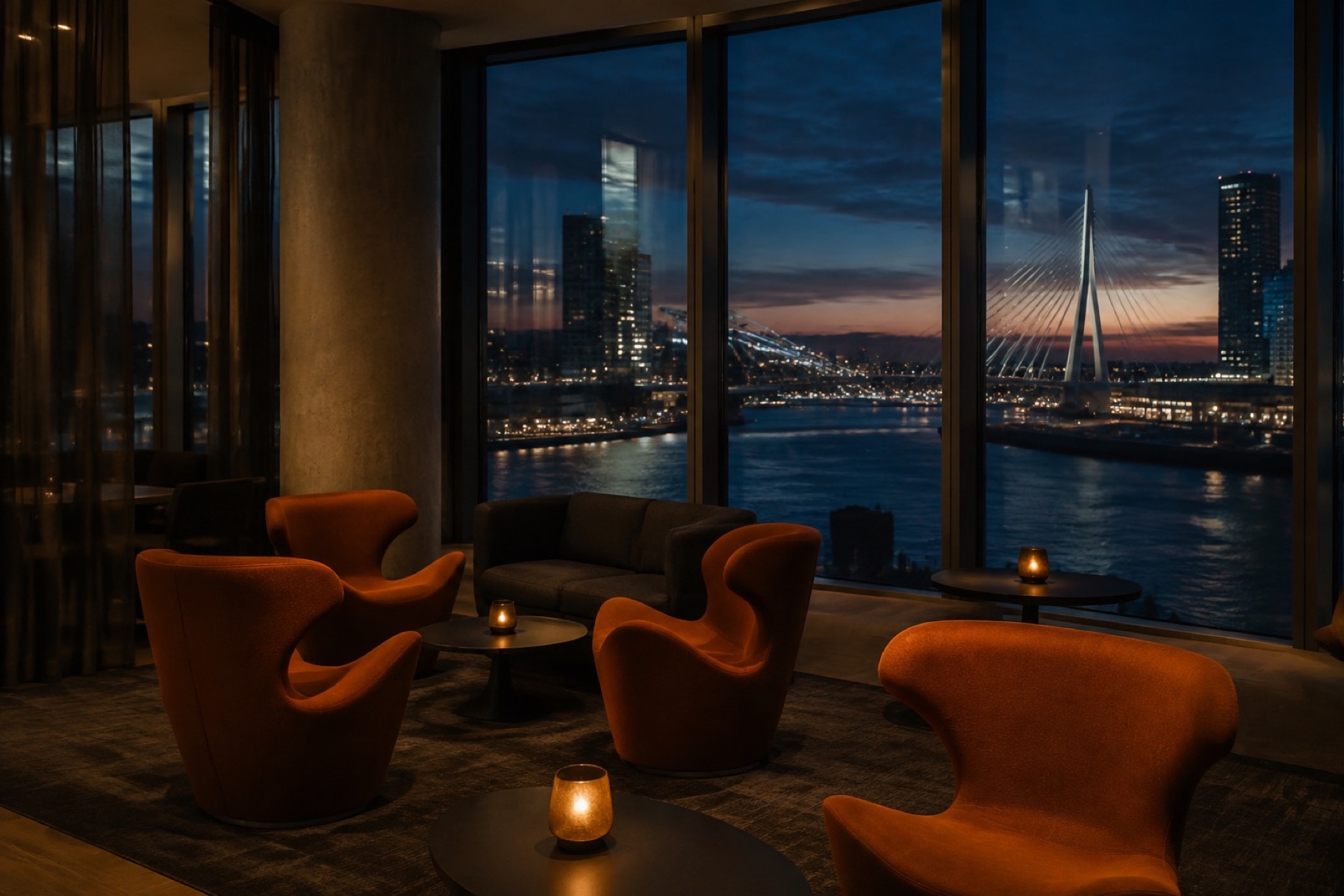 Loungestoelen bij een raam met avondzicht op de brug en het water